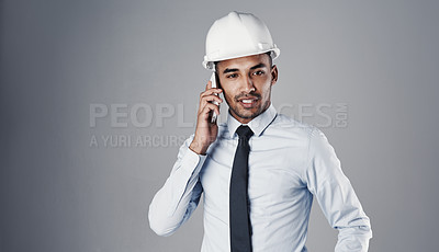 Buy stock photo Architect, helmet and phone call in studio for communication, construction and renovation update. Engineering, man and mobile on gray background for conversation, research and architecture project