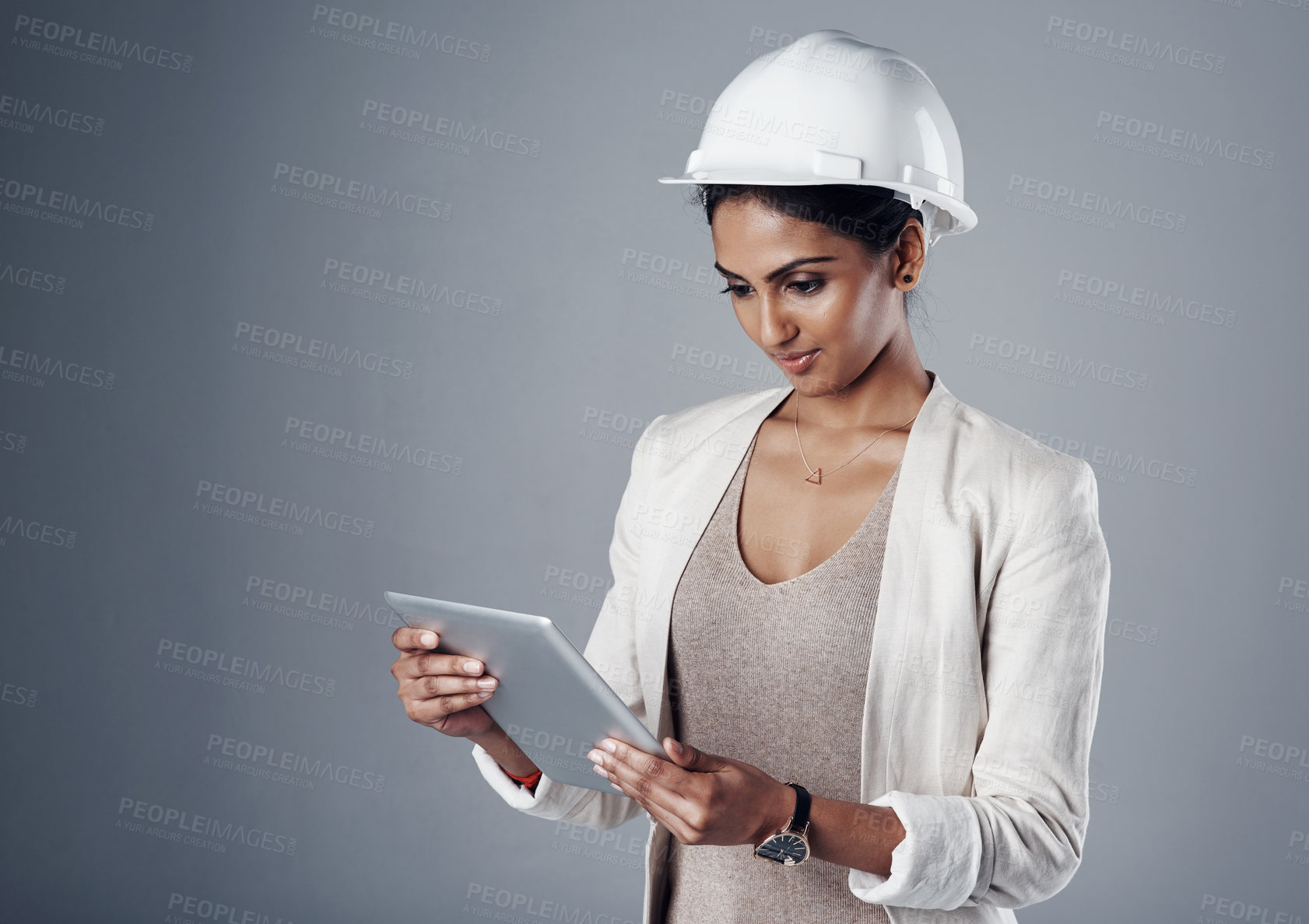 Buy stock photo Engineer, helmet and tablet in studio for construction, communication and renovation progress update. Development, technology and woman on gray background for project, research or architecture report