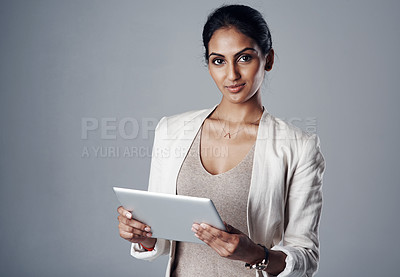 Buy stock photo Employee, woman and smile with tablet in studio for research as social media manager on gray background. Indian person, portrait and confident on internet for communication and online reviews