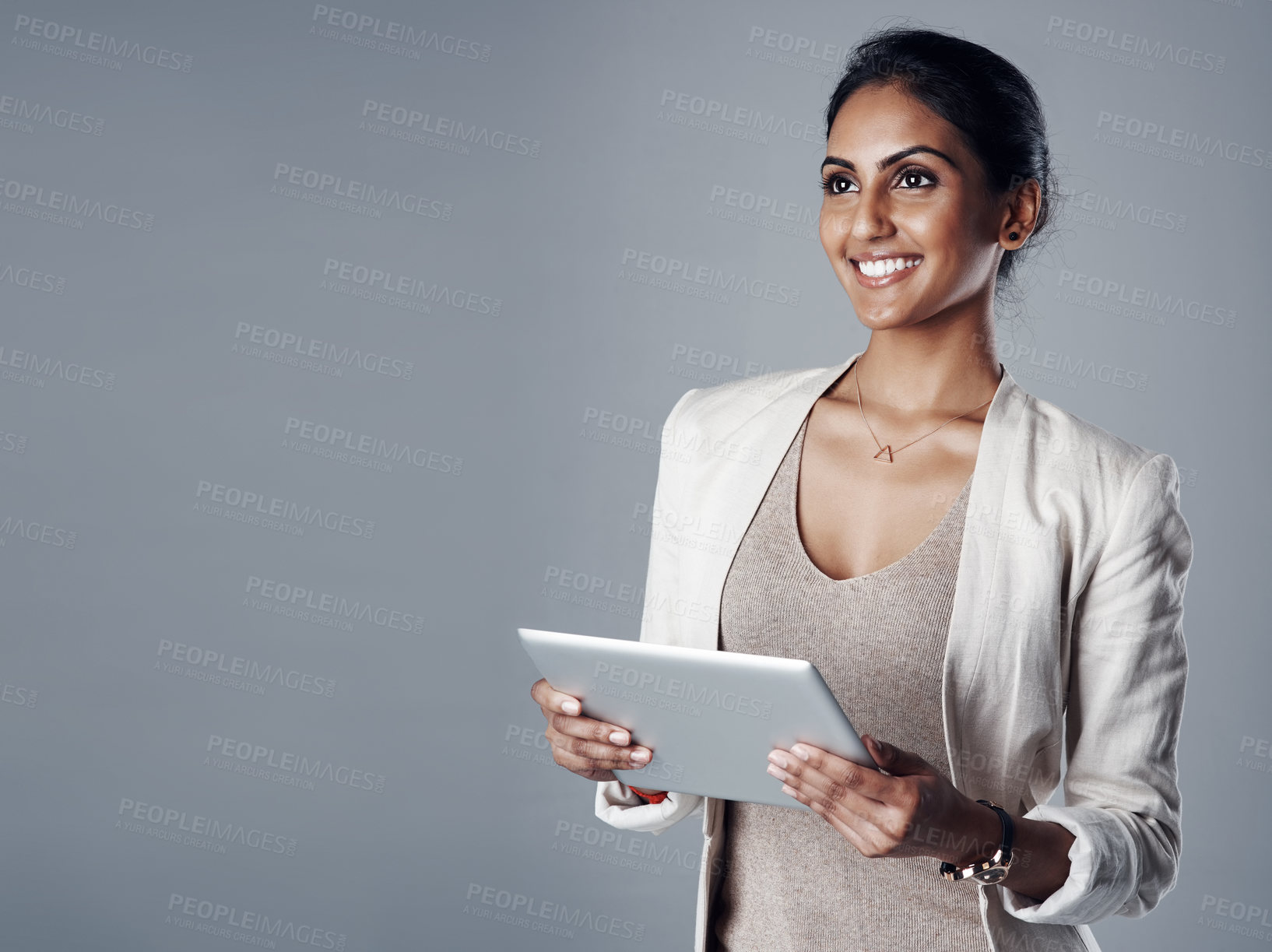 Buy stock photo Business, woman and happiness with tablet in studio for research as social media manager on gray background. Indian person, mockup space and thinking on internet for communication and online reviews