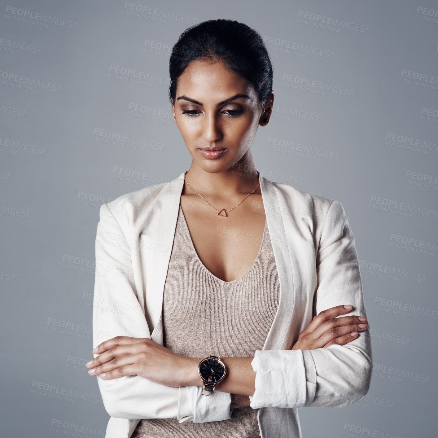 Buy stock photo Studio shot of a young businesswoman looking pensive against a gray background