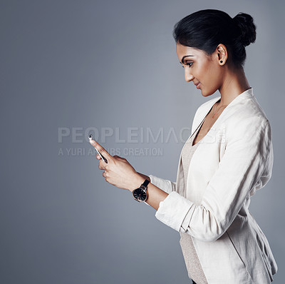 Buy stock photo Business, smile and woman with a smartphone, typing and online calendar against a grey studio background. Female person,  event organizer and model with a cellphone, search internet and website info