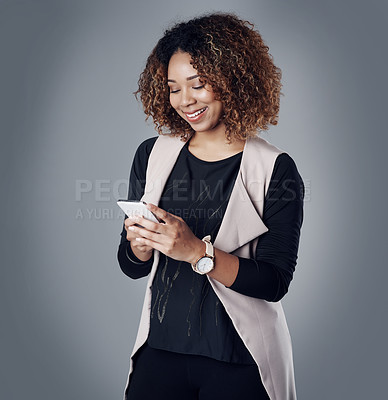 Buy stock photo Business, happy and woman with a smartphone, typing and online reading on a grey studio background. Female person, employee and consultant with a cellphone, search internet and website information