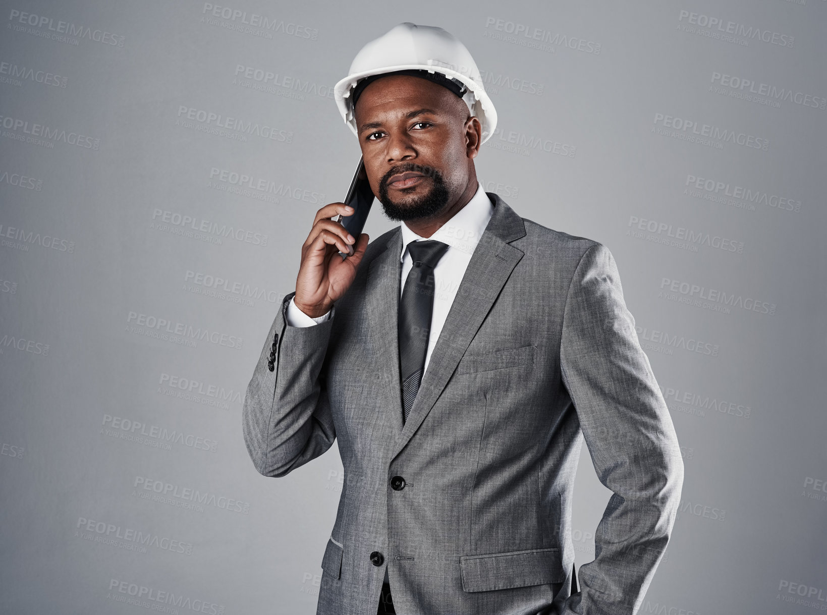 Buy stock photo Phone call, construction and portrait of man in studio for architecture, engineering and building project. Contractor, gray background and person on smartphone for contact, conversation and talking