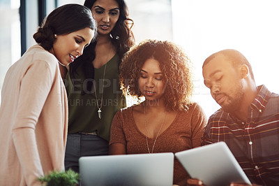 Buy stock photo Shot of a group of young professionals using wireless technology together in a meeting