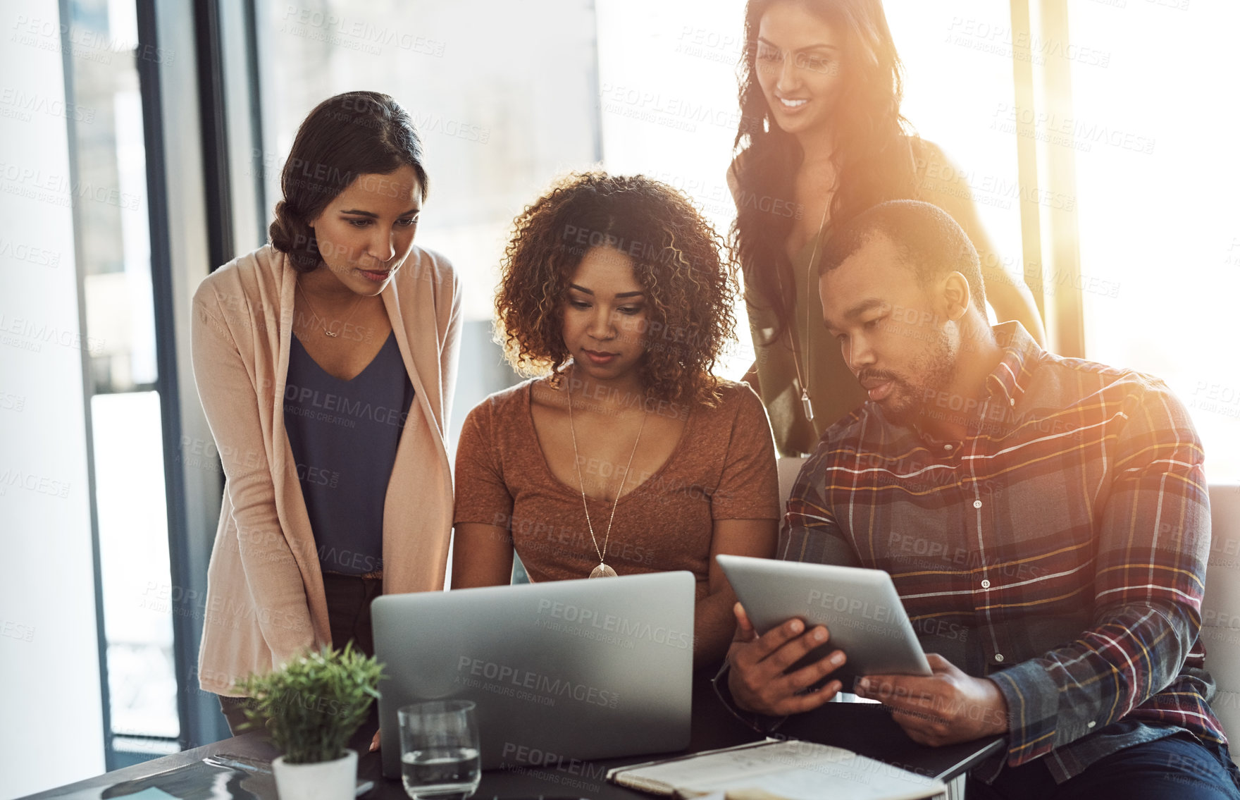 Buy stock photo Shot of a group of young professionals using wireless technology together in a meeting