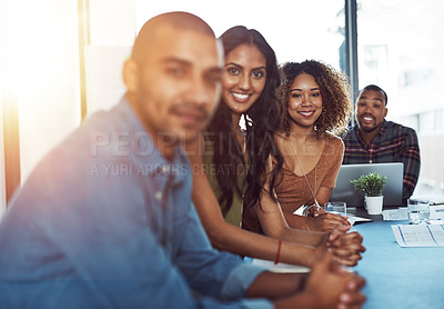 Buy stock photo Shot of a businesswoman standing out over the rest of her colleagues in a boardroom