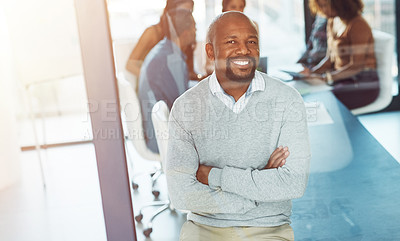 Buy stock photo Shot of a businessman posing with his arms crossed in a boardroom