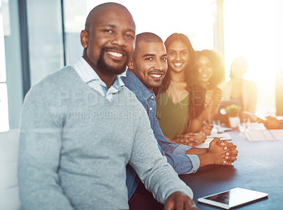 Buy stock photo Shot of a businessman standing out over the rest of his colleagues in a boardroom