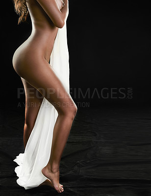 Buy stock photo Studio shot of a sexy young woman posing with a white sheet