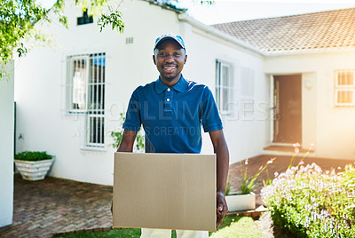 Buy stock photo Portrait of a young delivery man carrying a package during a delivery