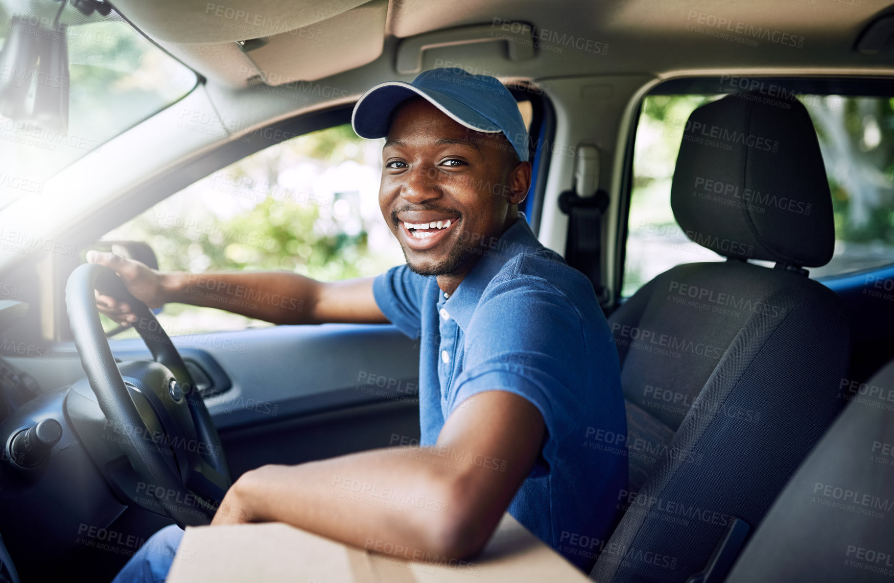 Buy stock photo Portrait of a young postal working sitting in his car during a delivery