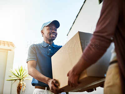 Buy stock photo Shot of a young postal worker delivering a package to a female customer