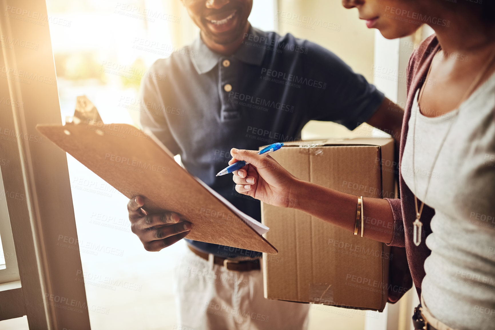 Buy stock photo Cropped shot of an unrecognizable woman signing for a home delivery