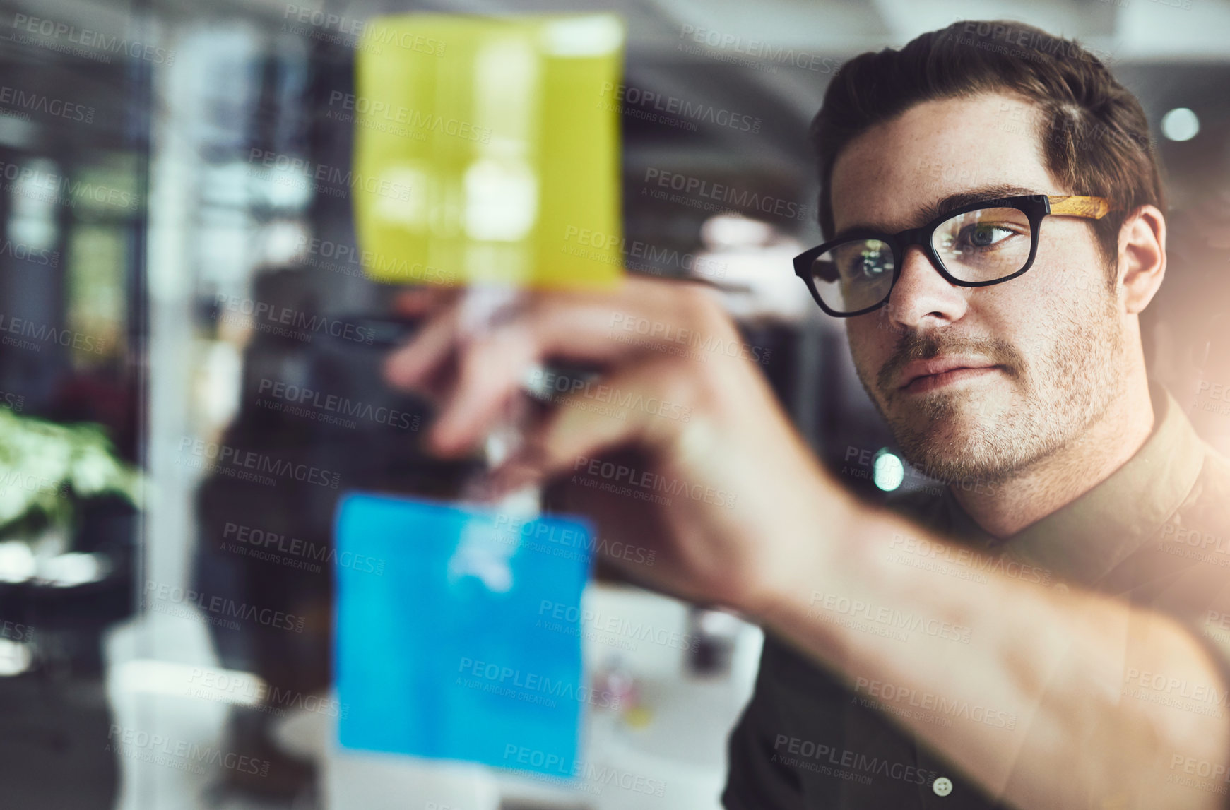 Buy stock photo Cropped shot of a young male designer planning on a glass board
