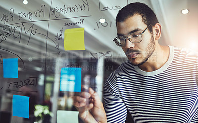 Buy stock photo Cropped shot of a young male designer planning on a glass board