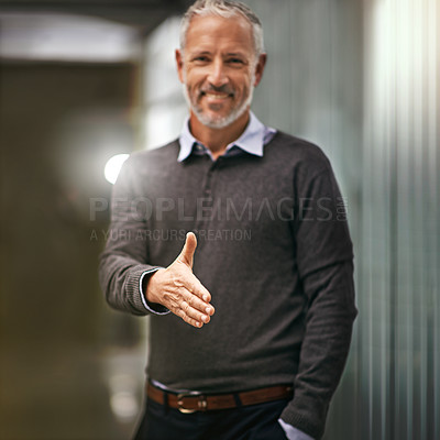 Buy stock photo Portrait of a businessman gesturing for a handshake in an office