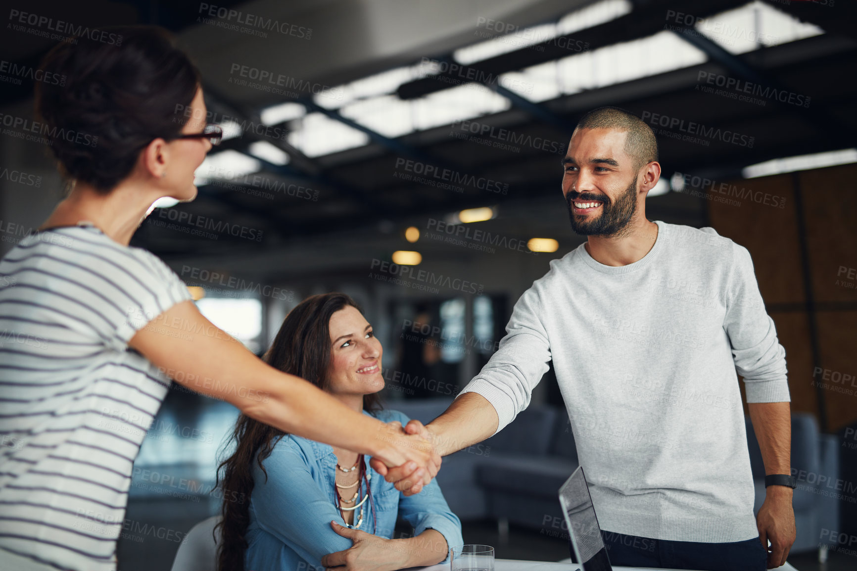 Buy stock photo Deal, handshake and partnership with business people in office together for agreement or contract. Smile, thank you or welcome with employee man and woman shaking hands in creative workplace