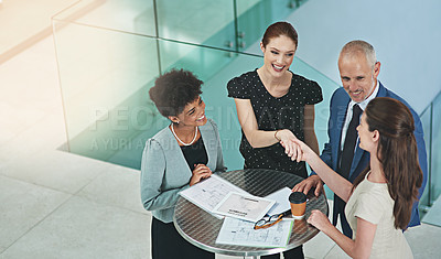 Buy stock photo Cropped shot of a group of businesspeople shaking hands during a meeting in an office