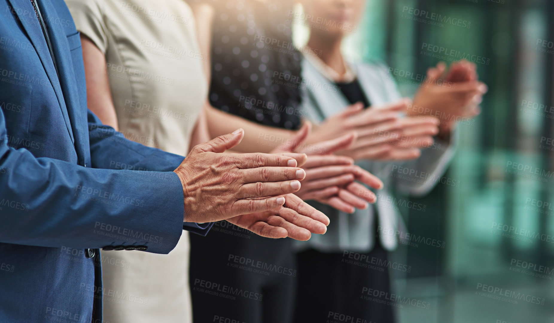 Buy stock photo Cropped shot of a group of unrecognisable businesspeople applauding together in an office