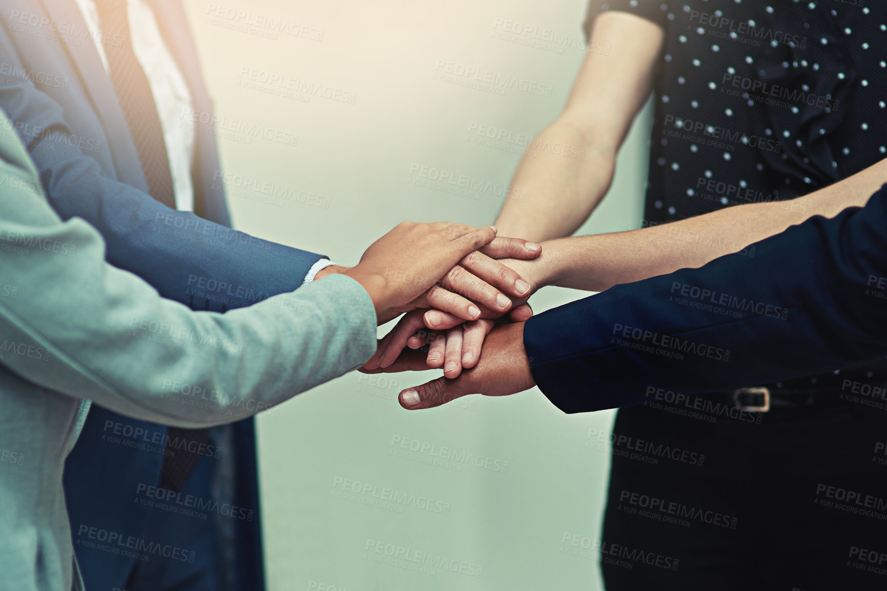 Buy stock photo Cropped shot of a group of unrecognisable businesspeople joining their hands together in unity