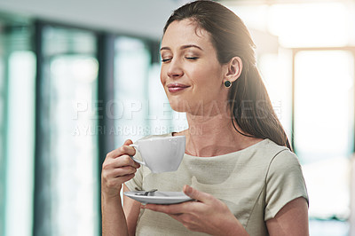 Buy stock photo Cropped shot of a young businesswoman enjoying a cup of coffee in an office