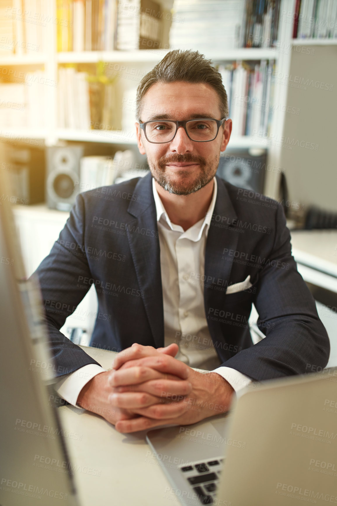 Buy stock photo Portrait of a businessman working at his computer in an office