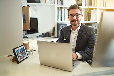 Buy stock photo Portrait of a businessman working at his computer in an office