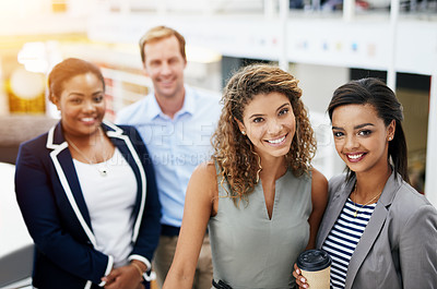 Buy stock photo Portrait of a group of smiling businesspeople standing together in a modern office