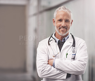 Buy stock photo Portrait of a mature male doctor standing in a hospital