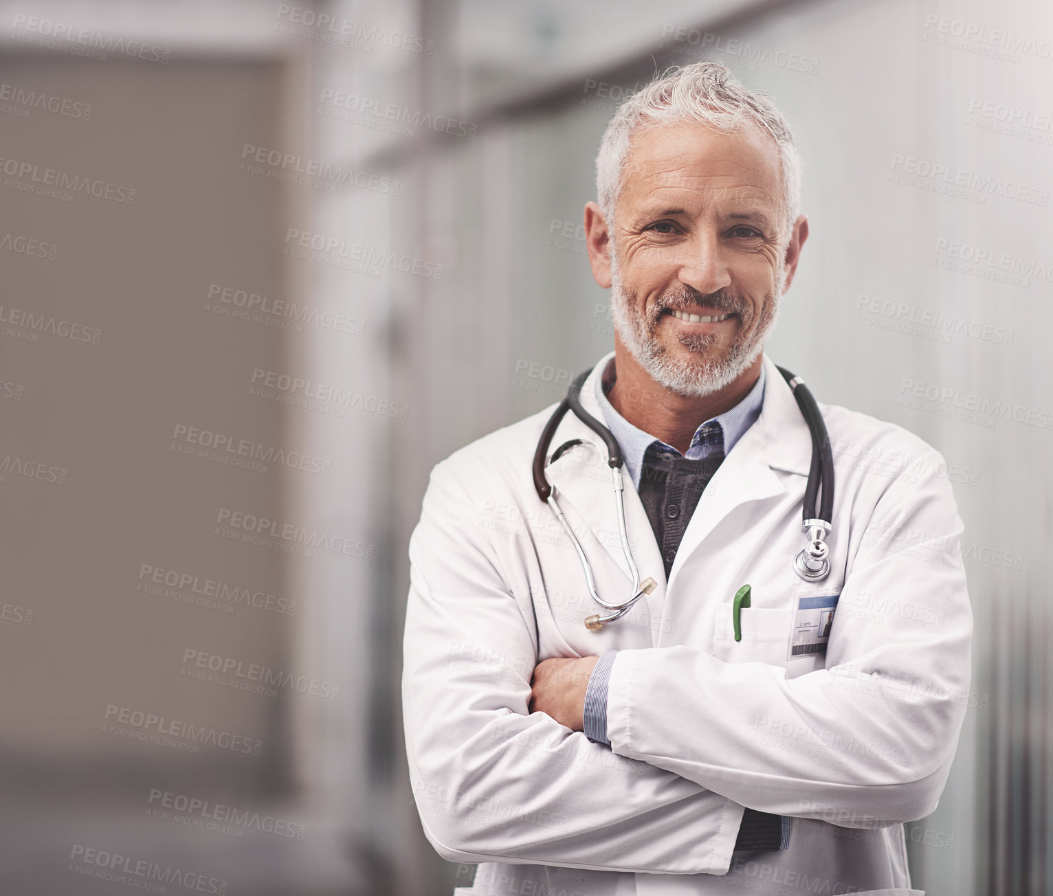 Buy stock photo Portrait of a mature male doctor standing in a hospital