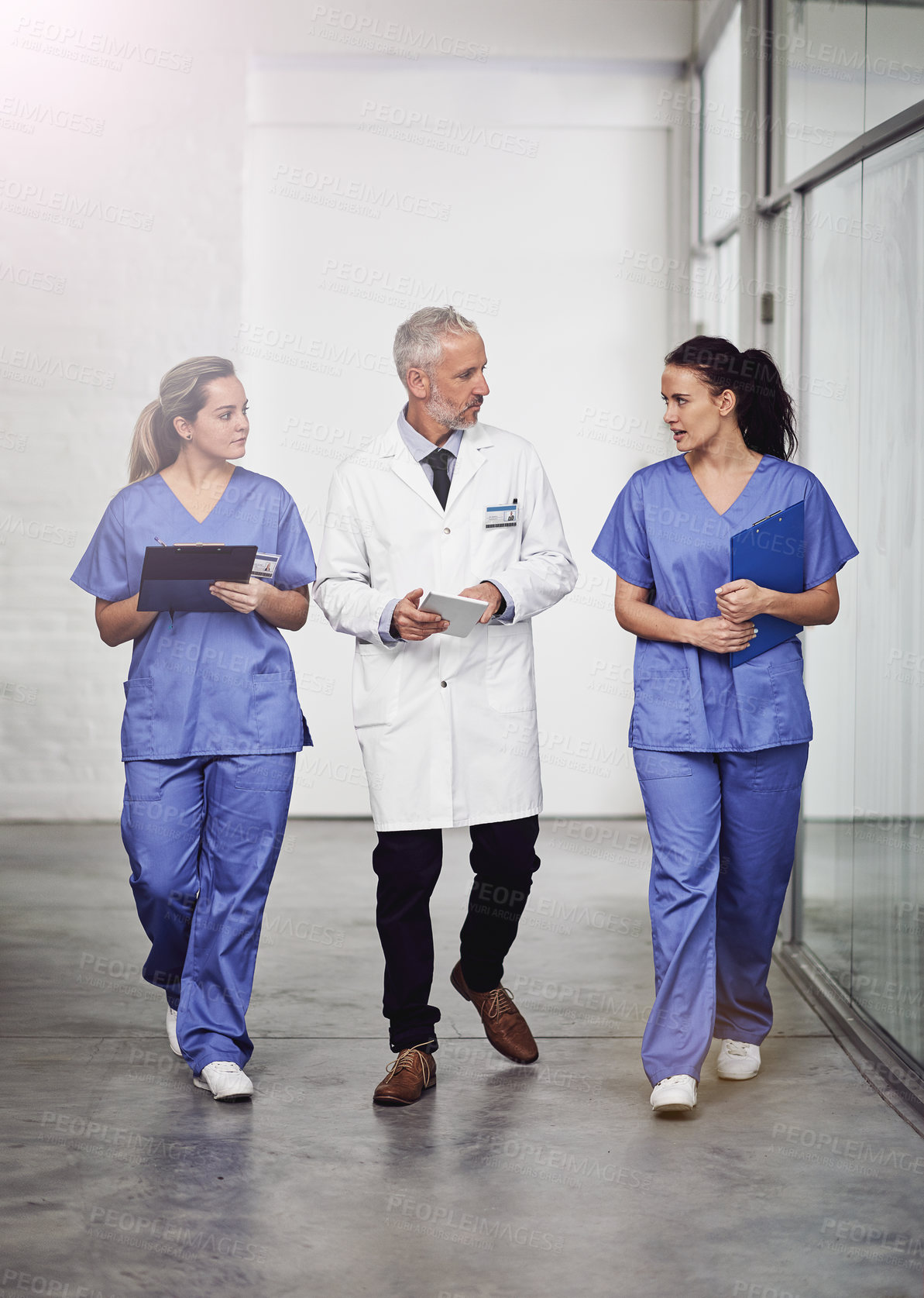 Buy stock photo Medical team, healthcare and doctors talking in a hospital with a clipboard and tablet for health insurance. Senior chief and nurses or a man and women together for a discussion, results and planning