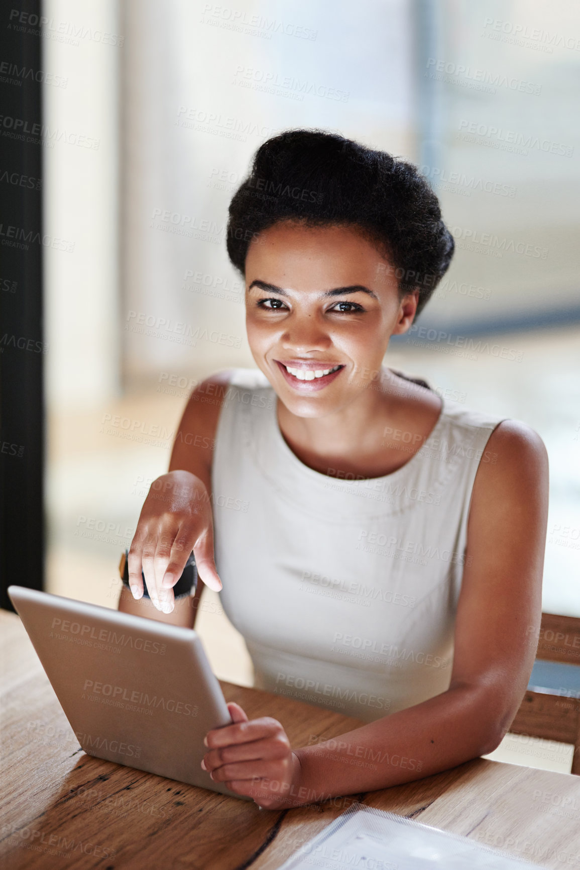 Buy stock photo Portrait of a smiling young businesswoman using a digital tablet in an office