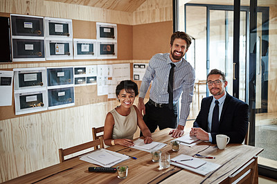 Buy stock photo Portrait of a group of colleagues working together around a table in an office