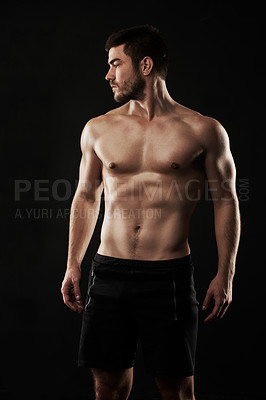 Buy stock photo Studio shot of a sporty young man isolated on black