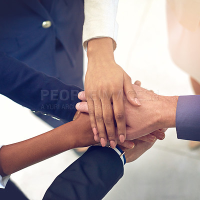 Buy stock photo High angle shot of a group of colleagues joining their hands together in unity
