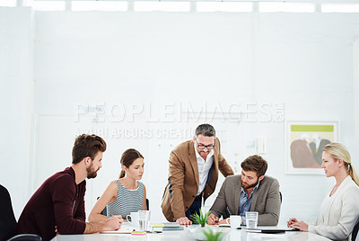Buy stock photo Shot of a group of designers having a meeting around a table in an office