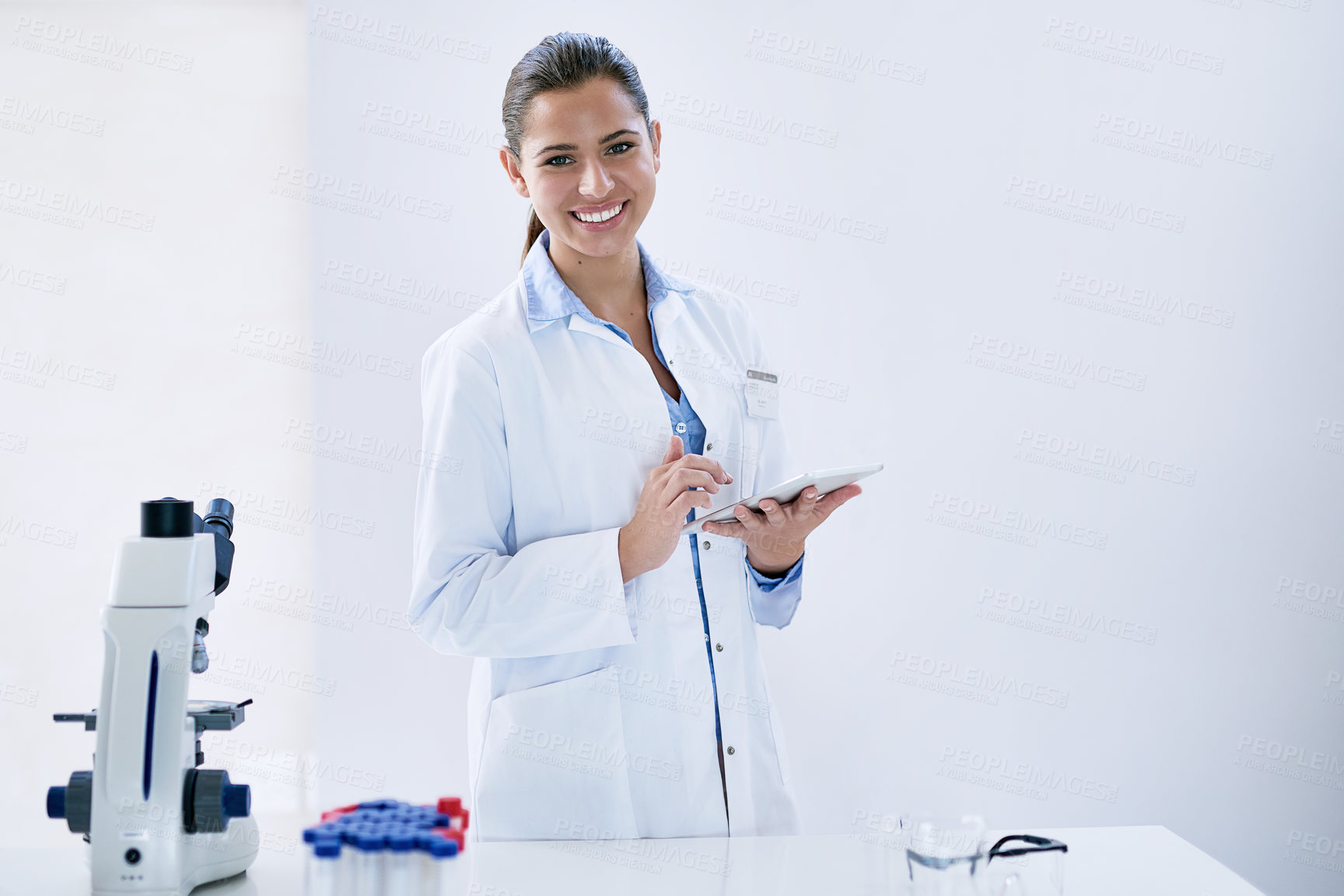Buy stock photo Woman, tablet and smile with laboratory, microscope and portrait for research and discovery. Scientist, science and lab coat for forensics, breakthrough and drug innovation and life extension