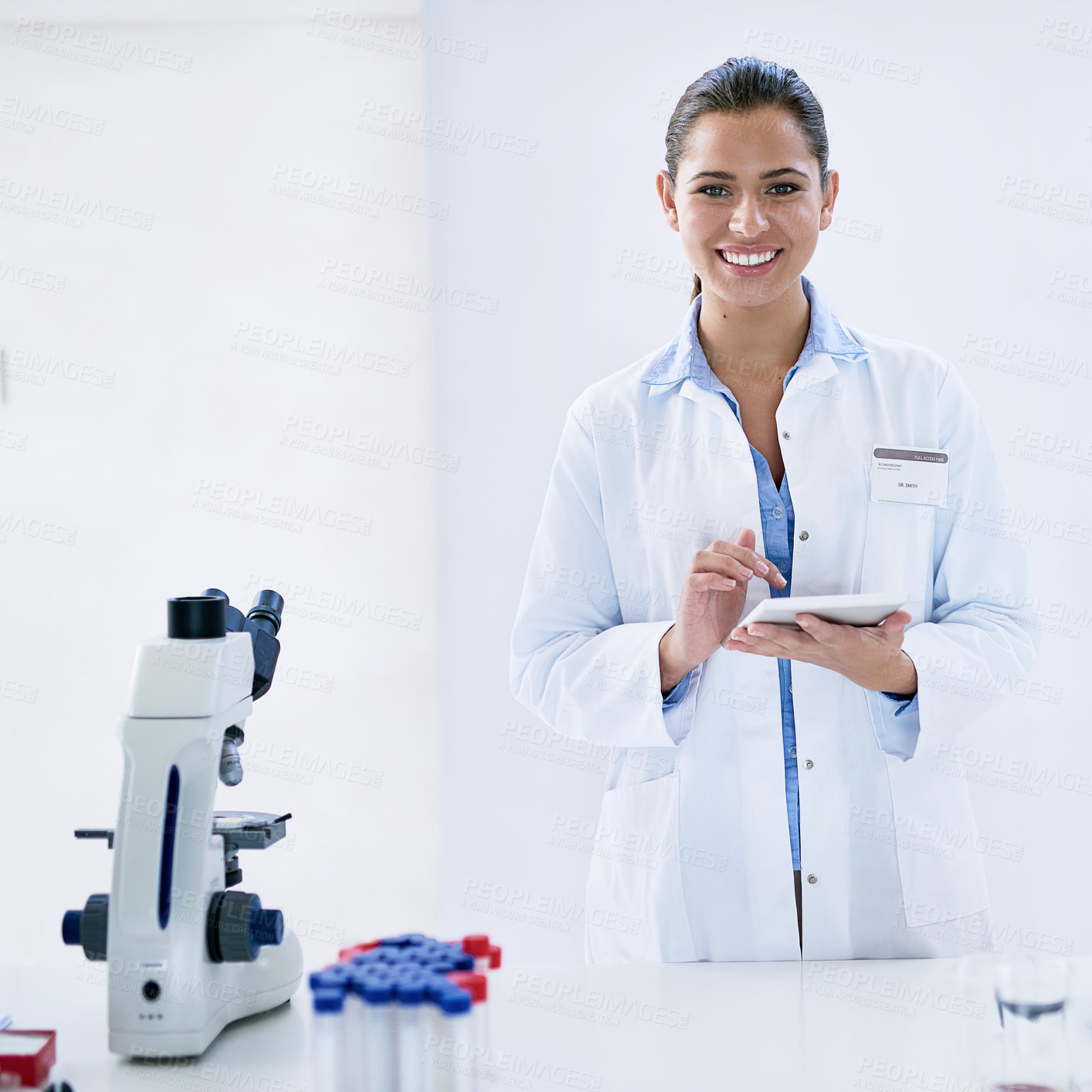 Buy stock photo Scientist, tablet and smile with laboratory, microscope and portrait for research and discovery. Woman, science and lab coat for forensics, breakthrough and drug innovation and life extension