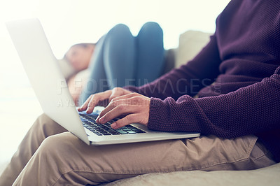 Buy stock photo Hands, man and laptop on sofa for remote work in morning with woman sleeping in home living room. People, computer and typing for report, article or creativity in freelance writing career on couch