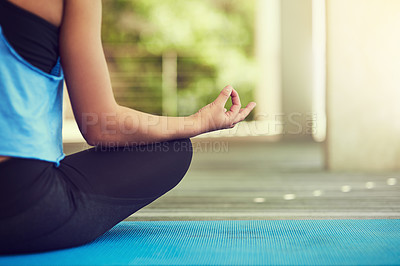 Buy stock photo Cropped shot of a young woman sitting in lotus position