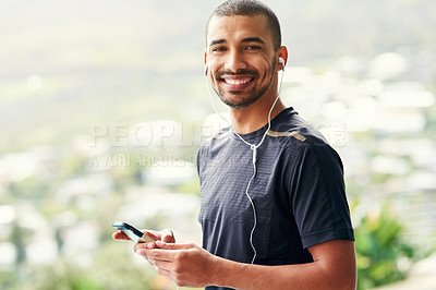 Buy stock photo Portrait of a sporty young man checking his playlist before a run