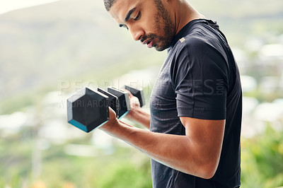Buy stock photo Cropped shot of a sporty young man lifting weights outside