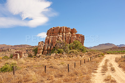 Buy stock photo Rock, sky and landscape in nature with path, ecosystem and natural habitat creation in wallpaper. Boulder, bushes and driveway in environment with dry climate, travel and ecology in Arizona reserve