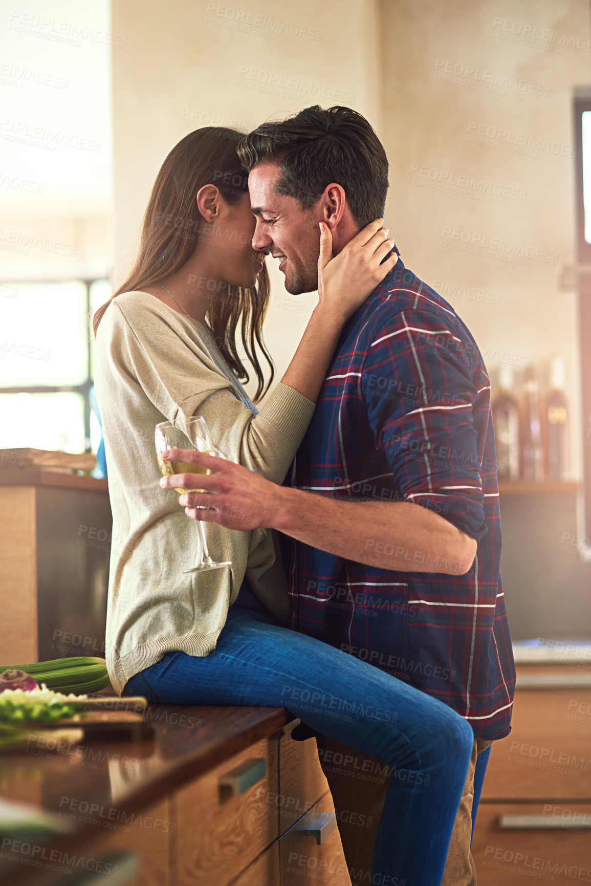 Buy stock photo Love, home and couple with hug in kitchen for marriage, commitment or intimacy on weekend. Happy, woman and man with glass of wine in house for and anniversary, care or romantic bonding in connection