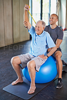 Buy stock photo A trainer helping an elderly man with fitness