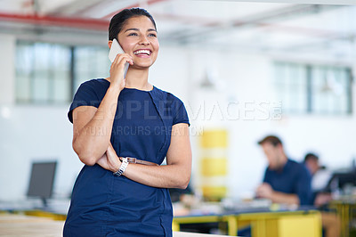 Buy stock photo Shot of an attractive young businesswoman using a cellphone in her office