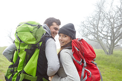 Buy stock photo Rearview shot of a young couple hiking along a nature trail