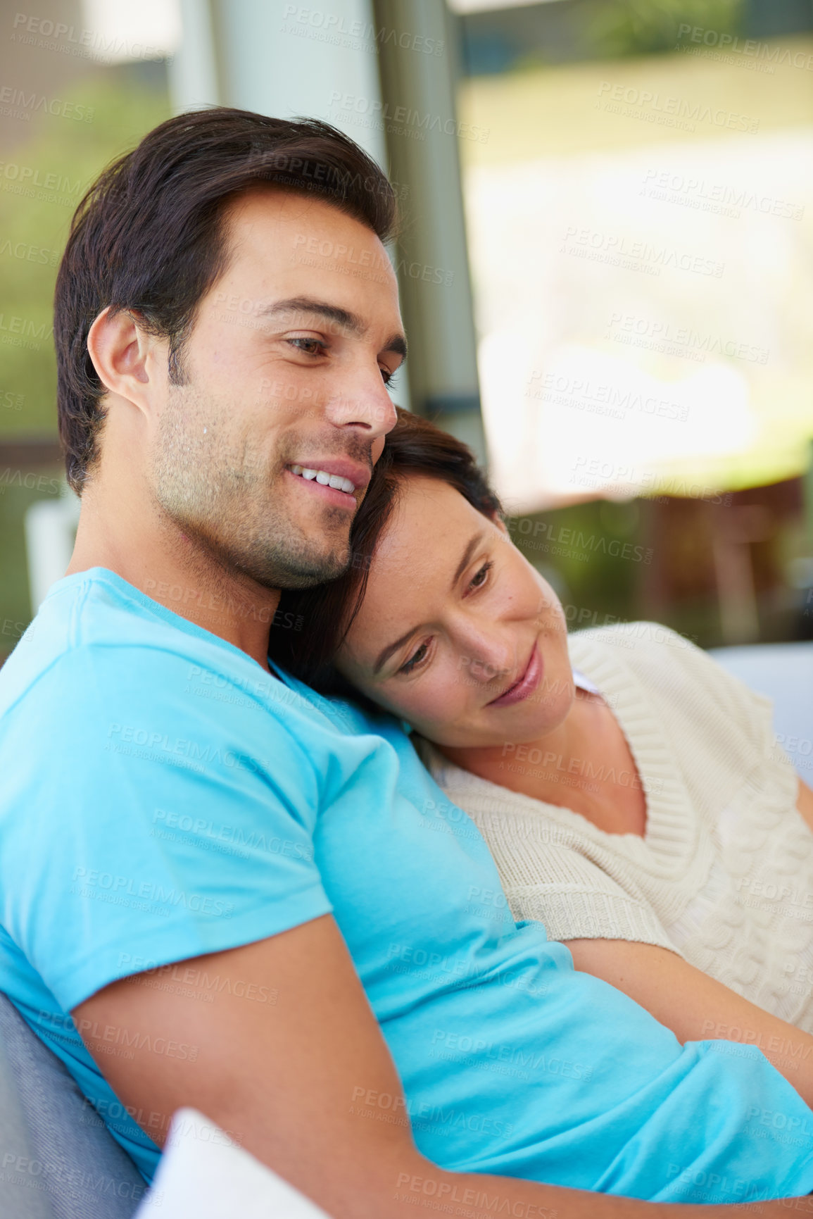 Buy stock photo Shot of a married couple relaxing on the sofa at home