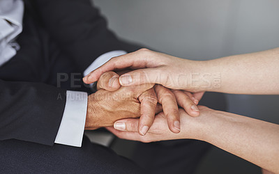 Buy stock photo Cropped shot of two compassionate colleagues holding hands